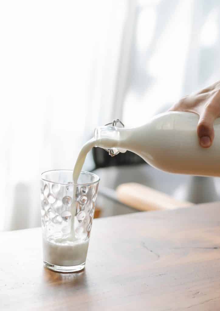 pouring milk in a cup