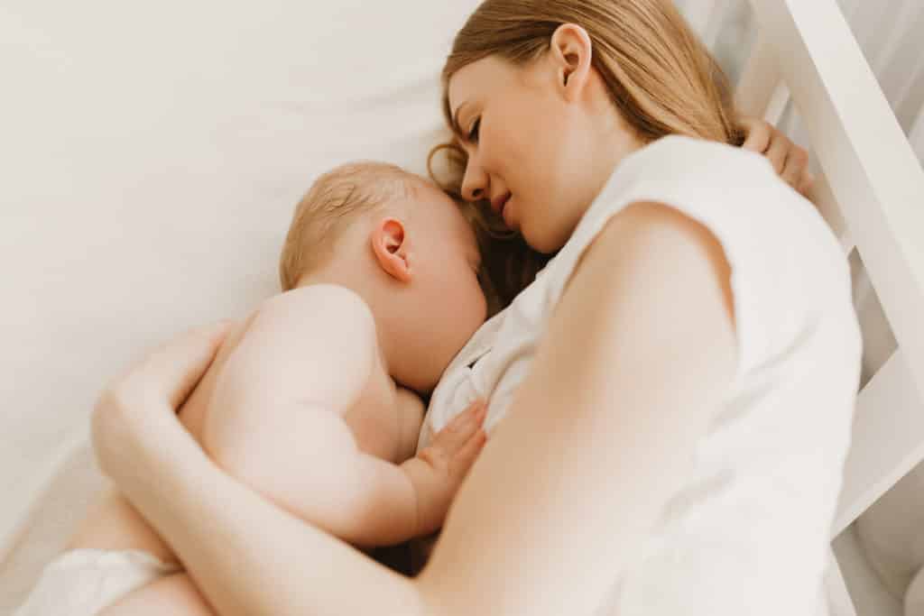 woman breastfeeding a child 